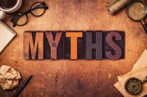 MYTHS written in bold 3D letters on a wooden background